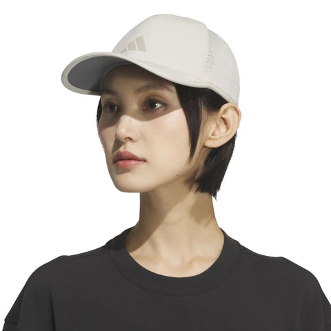 Woman wearing Superlite Hat For Women Lightweight Moisture Wicking Cap For Gym Ready Workouts And Training with UPF 50 Sun Protection in beige.