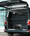 Fireproof Document Safe Box With Dual Lock System placed in an SUV trunk, showing sturdy handle and portable design, black color