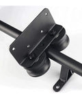 Close-up of Black Sliding Barn Door Kit With Floor Roller Wheels showing black steel hardware and round tube track.