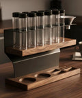 Two Tier Wooden Coffee Bean Storage Rack With Airtight Glass Jars Featuring Black Vent Lids Countertop Flex Freshness Sealer Brew Day Ready Kitchen Organization Set Keep Beans Crisp on a kitchen countertop.