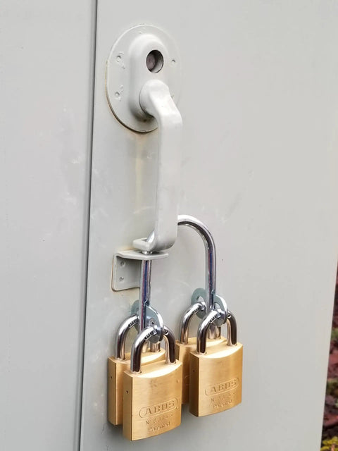 Heavy Duty Multi User Padlock Holder Provides Solid Gate Or Door Security Supports Four Independent Keys with two padlocks mounted.