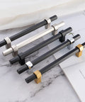 Ten Pack 3 Inch Hole Center Black And Gold Cabinet Pulls Matte Black Hexagon Bar With Brushed Gold Bases on marble