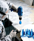Diamond core drill bits set, 16 pcs, blue brazed bits for tile and stone; drill in use (front view).