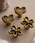 Antique Brass Heart Cabinet Knobs With Hammered Texture Solid Metal Drawer Pulls And Handles For Boho Nursery Dresser Kitchen Cabinets And Bathroom Vanity Decor visible in a 2-pack with flower design.