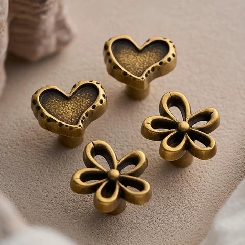 Antique Brass Heart Cabinet Knobs With Hammered Texture Solid Metal Drawer Pulls And Handles For Boho Nursery Dresser Kitchen Cabinets And Bathroom Vanity Decor visible in a 2-pack with flower design.