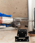 Person drilling into a frame with Heavy Duty Furniture Hinges Set In Black Carbon Steel visible in the foreground.