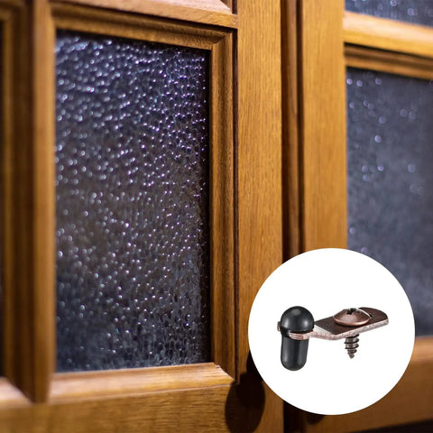 Rock Solid Antique Bronze Glass Retainer Clips Bundle Arrives Fully Loaded With All Needed Screws And Snug Silicone Sleeves For Zero Hassle Cabinet Door Setup And Dependable Everyday Performance, showing clips mounted on textured glass cabinet doors.