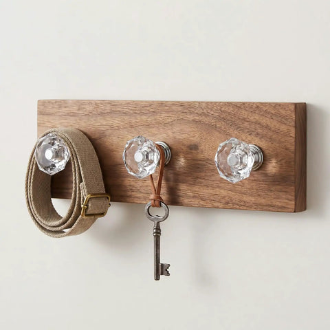 Crystal Clear Acrylic Dresser Knobs 20 Pack Diamond Shape Cabinet Knobs on wooden board, holding belt and key.