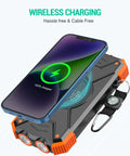 10,000mAh Solar Power Bank With Wireless Charging And 20W USB C Fast Charge, phone charging wirelessly on top, dual LED flashlight visible