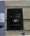 Kick Up Your Security Game With This Bulletproof Plastic Shell Built Tough For Ic And Id Card Readers Providing Flawless Access Control Protection For High Traffic Business Environments Where Reliability Is Non Negotiable, featured on an ID card reader mounted on brick wall.