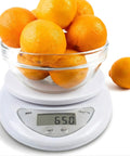 High Precision Digital Kitchen Scale For Cooking And Baking With 5 Kg 11 Lb Capacity showing 650g of oranges in glass bowl