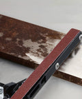 Heavy Duty Belt Sander Attachment Bracket Compatible With 100Mm And 125Mm Angle Grinders showing red grit belt on metal surface.