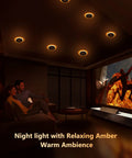 Slick 4 Inch Black Canless Recessed Lights 36 Pack in amber night light mode illuminating a cozy living room.