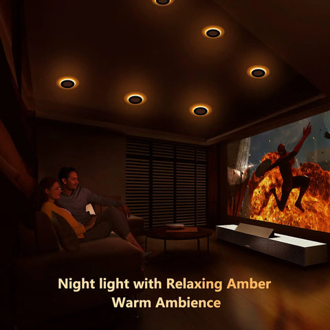 Slick 4 Inch Black Canless Recessed Lights 36 Pack in amber night light mode illuminating a cozy living room.