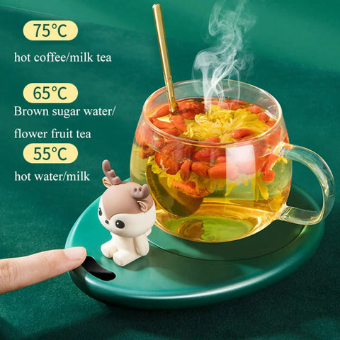 Electric Mug Warmer With Three Temperature Settings And Auto Shut Off Keeps Your Morning Joe Piping Hot All Day Long Smooth Desktop Beverage Heater For Coffee Or Hot Cocoa In White with a steaming mug on green surface.