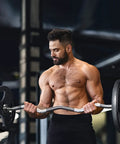 Man using 2 Inch EZ Curl Bar With 85 Lb Plates, 350 Lb Weight Capacity Olympic Curl Barbell For Biceps And Triceps, 47 Inch Rackable Bar