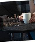 Vintage Steam Locomotive Model Sculpture for Desk Decor and Living Room on a table beside a person with a mug