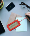 Transparent Mini Lucky Number Picker For Parties on a desk with stationery, red and orange design, clear display showing random numbers.
