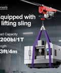 Heavy Duty 110 Volt Electric Hoist Winch With 2200 Lb Capacity lifting a machine with purple sling in warehouse.