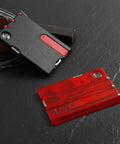 14-In-1 Survival Card Tool With LED Light, ultra compact 2Cr13 stainless steel multitool in black red on dark surface
