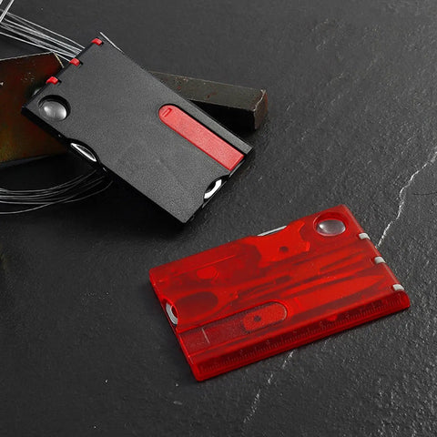 14-In-1 Survival Card Tool With LED Light, ultra compact 2Cr13 stainless steel multitool in black red on dark surface