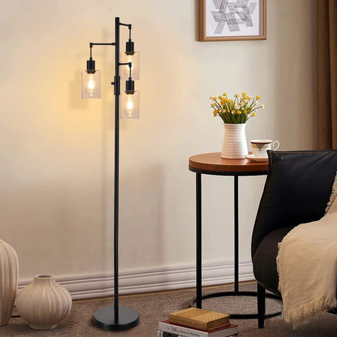Three Light Industrial Floor Lamp With Glass Shades For Living Room Dope Vibe next to table with flowers