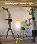 100W LED Tripod Work Light with Stand illuminating a construction site, 360 Degree Coverage, workers on ladders, clear visibility.