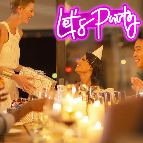 Festive scene with "Let's Party" neon sign, gift exchange, and lit candles, Lit Dimmable LED Neon Sign For Wall Decor 16x7 Inches White Neon Art Light Perfect For Bachelorette Parties Engagements Birthdays And Wedding Celebrations