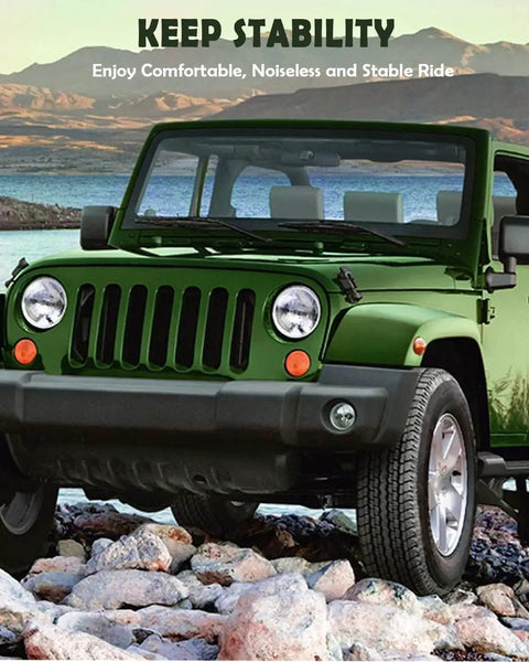 Green off-road vehicle on rocky terrain with mountains in background