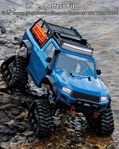 Blue RC off-road truck with roof rack, LED light bar, and oversized knobby tires on rocky terrain