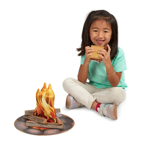 Child playing with Campfire S'mores Pretend Play Set With 23-Piece Toy Food Kit including flames and marshmallows.