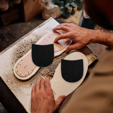 Craftsman applying Non Slip Rubber Heel Pads For Shoes Anti Slip Cushion Shoe Sole Repair Cushion Boots And Sneakers Footwear Protection Durable Rubber Patches For Everyday Comfort And Long Lasting Durability to shoe insole.