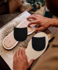 Anti Slip Shoe Heel Repair Pads 1 Pair Rubber Sole Protector Cushions on shoe soles, black nonskid patch being applied