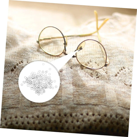 Rimless Glasses Washers And Metal Flat Gaskets Eyeglass Repair Kit 200 Pcs Fasteners displayed with round glasses on fabric