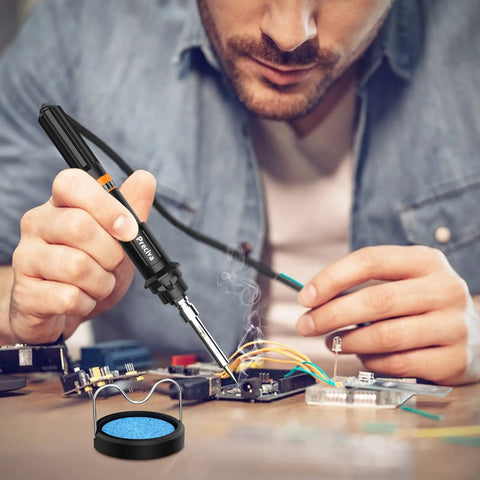 Man using Pro Grade Soldering Iron Kit With 135W Adjustable Temperature And Rapid Heat Ceramic Thermostatic Core for electronics repair