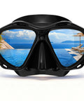 Scuba Mask For Grownups And Teens With Panoramic HD Lenses Snorkel Goggles With Nose Cover reflecting a pool and ocean view in lenses.