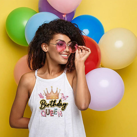 Woman wearing Birthday Queen Iron On Transfer Kit tank top against colorful balloons background.
