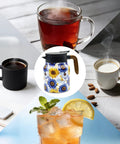 Sunflower Floral 35 Ounce Tea Pot With Infuser Insulated Stainless Steel Kettle for Loose Leaf Tea Big Capacity in center with beverages.