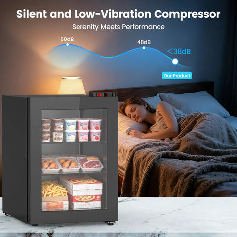 Space Savvy 2.4 Cu Ft Mini Freezer With Clear Glass Front Door showcasing food items, near a sleeping person in a cozy bedroom.