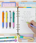 Image of 5 Pack Gel Pens 0.5mm Fine Point Retractable With Diamond Barrel Quick Dry Ink For Journaling Note Taking Office And School Supplies Smooth Writing With Rolling Clip And Comfortable Grip Includes Z3 Contrast Color on an open notebook.
