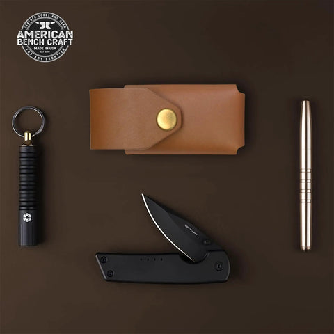 Tan Leather Multitool Holster For Suspension And Suspension NXT Belt Clip Pouch with accessories on dark background.