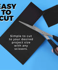 Pack Of 25 Non Adhesive Flexible Magnetic Sheets For Arts And Crafts shown being cut with scissors on a blue background