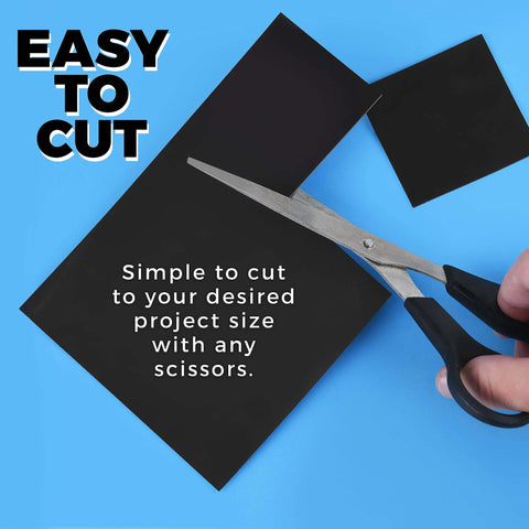 Pack Of 25 Non Adhesive Flexible Magnetic Sheets For Arts And Crafts shown being cut with scissors on a blue background