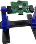Adjustable Circuit Board Clamping Kit For Soldering And Repairs with wide clamp holding a PCB, durable metal base, hands-free use