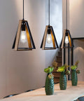 Farmhouse Pendant Light Kit Two Pack with Adjustable Hanging Lights for Kitchen Island Black and Wood Rustic Fixture for Dining Room Hallway Bar Porch Cafe No Fuss Easy Install, shown illuminating a modern dining area with elegant greenery.