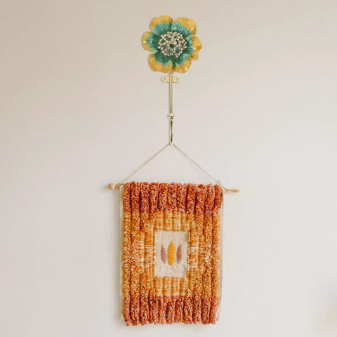 Sweet Vintage Flower Wall Hooks That Are Dang Handy For Hanging Coats Keys And Kitchen Towels Without Taking Up Valuable Space Plus The Rustic Design Looks Totally Legit In Any Room with colorful flower above woven wall hanging.