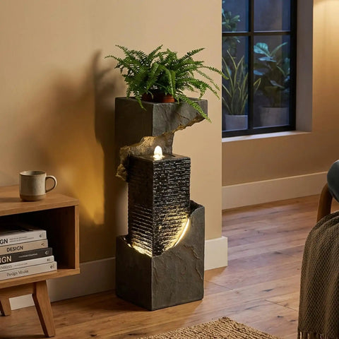 35.4 Inch Tall Indoor Outdoor Dope Waterfall Fountain with LED Lights, resin floor-standing in room setting, plant on top
