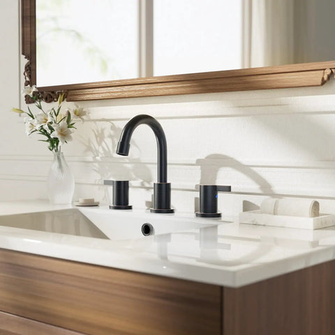 Oil Rubbed Bronze 8 Inch Widespread Bathroom Faucet With Two Handles For Three Hole Mount Includes Valve And Metal Pop Up Drain Built To Last For 6 To 12 Inch Widespread Setups WF015-1-ORB installed on a white sink with wooden vanity in bathroom