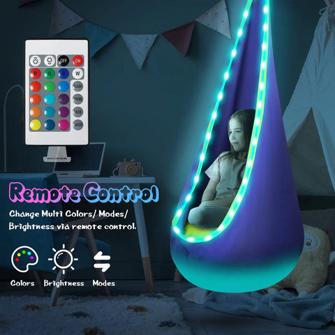 Light Up Kids Pod Swing Chair with LED Lights, child sitting inside with remote control, cozy sensory hammock indoors