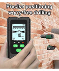Straight Shooting Wall Scanner And Stud Finder With Four In One Metal Detection And AC Voltage Sensing To Nail Down Hidden Joists And Live Wires Safely Without Drywall Damage held in hand near brick wall.